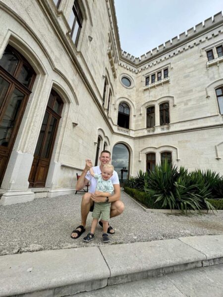 Father And Son In Front Of Historic Building