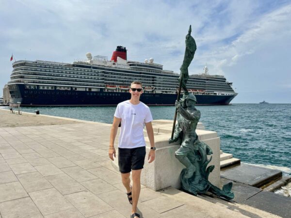 Man Walking Near Cruise Ship