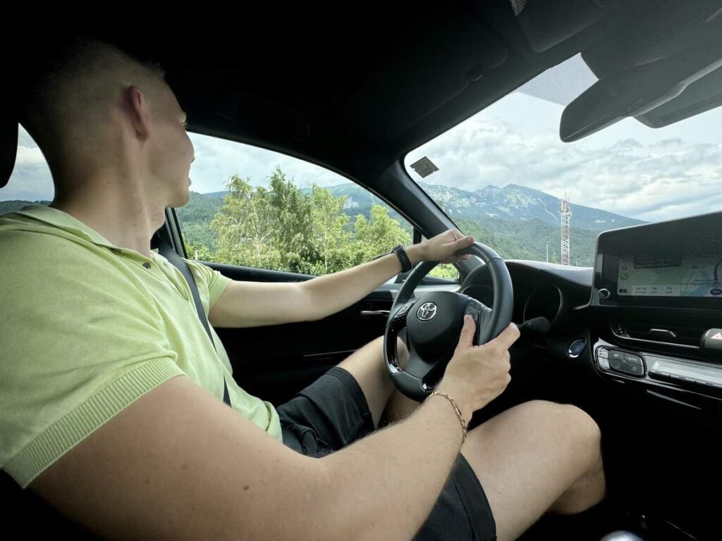 Man Driving Car With Mountain View Man Driving Car With Mountain View