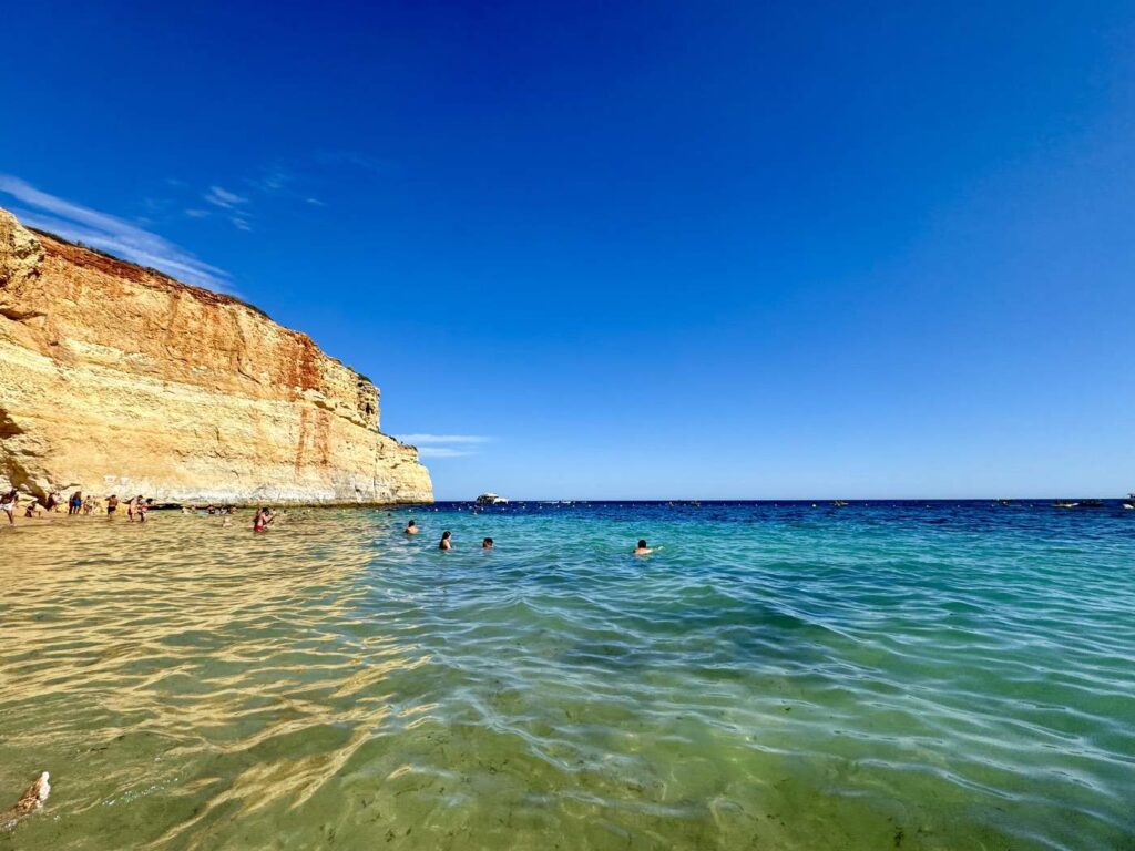 Enjoying clear waters at Praia da Marinha beach in Algarve Portugal Enjoying clear waters at Praia da Marinha beach in Algarve Portugal