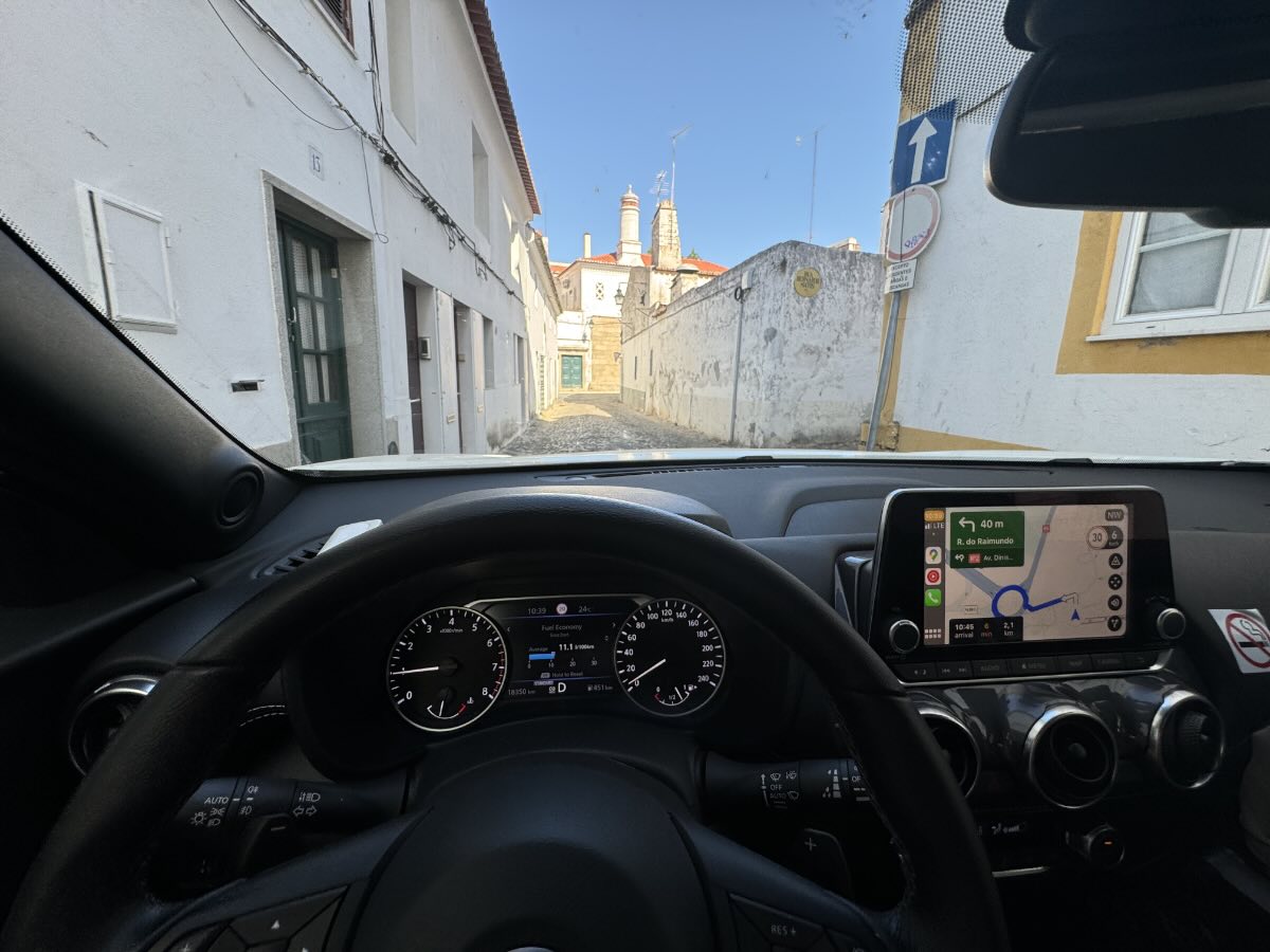 driving rental car portugal village Driving a rental car through a traditional Portuguese village with GPS navigation